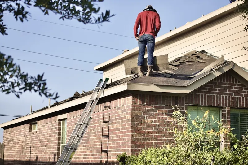 Professional roofer working on a residential roof in Clark